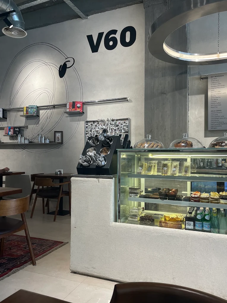 V60 Café pastry counter beneath its stainless-steel ceiling light