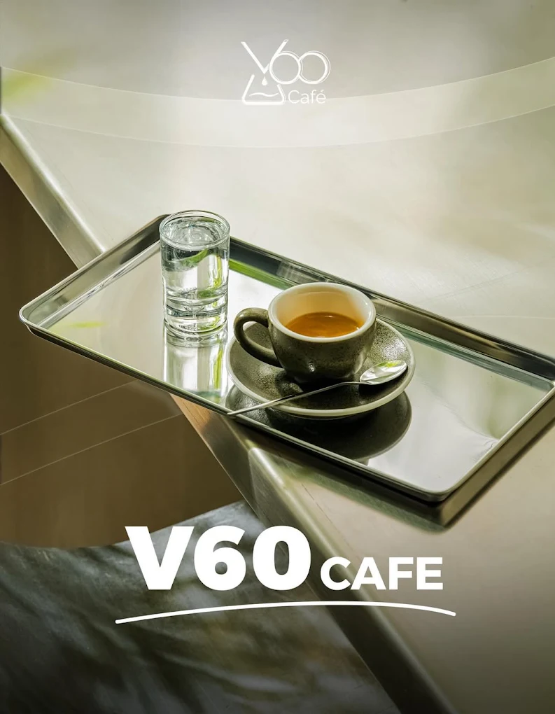 Espresso and sparkling water served on a stainless-steel tray