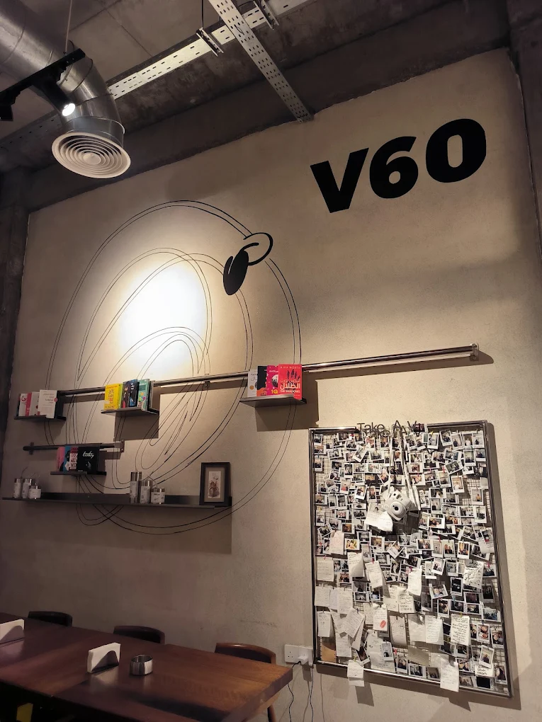 V60 wall installation filled with guest photographs and notes